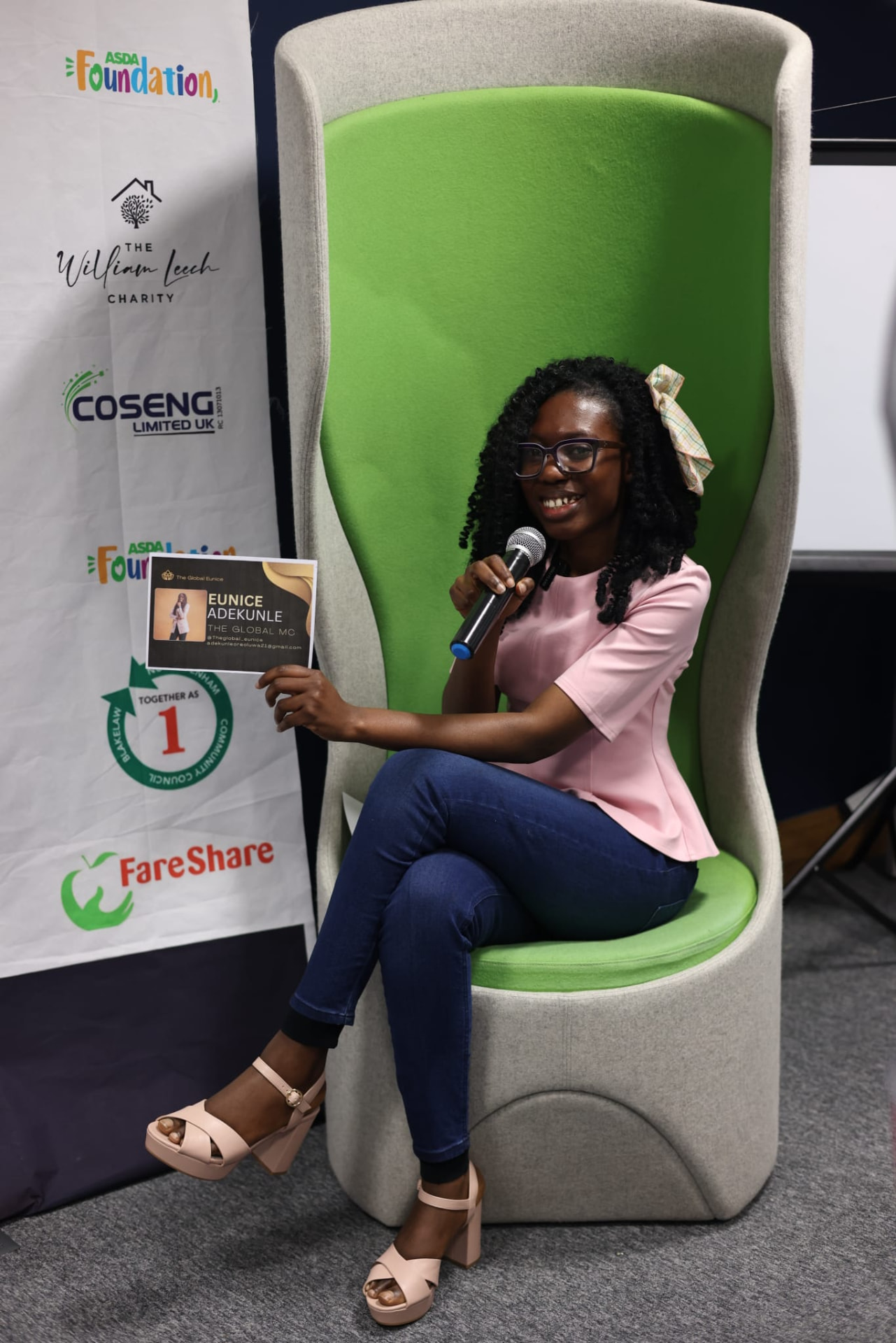 Eunice Adekunle hosting an event with a microphone